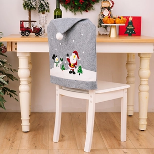Gray Christmas chair cover with Santa Claus and Snowman prints in a cozy home setting