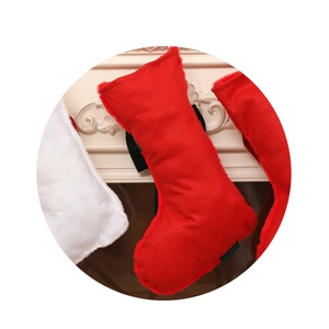 Red sequined Christmas stocking with white faux fur trim for festive fireplace decoration