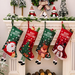 Detail of four Christmas stockings with hanging legs and Merry Christmas text on mantel