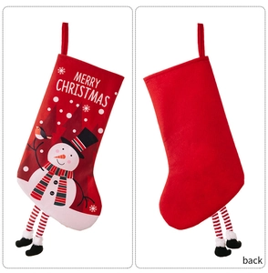 Detailed view of red Christmas stockings with snowman print and hanging legs