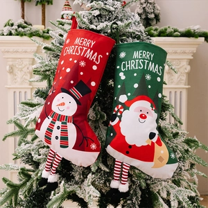 Detail of Christmas stockings with snowman and Santa patterns hanging on a tree