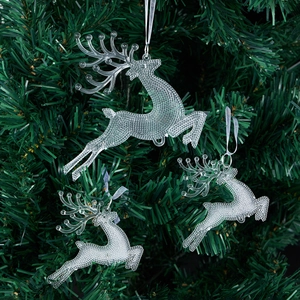 Three clear acrylic reindeer ornaments with bead texture hanging on a Christmas tree