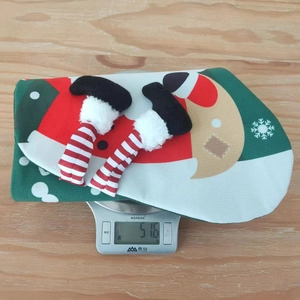 Detailed view of lightweight 51.6g festive Christmas stocking with plush striped legs