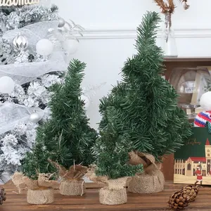 Miniature green Christmas tree set with burlap base for holiday tabletop decoration