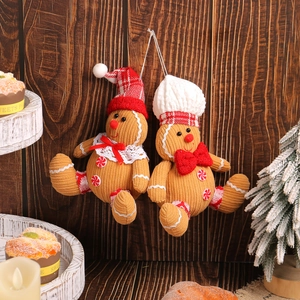 Charming gingerbread man plush ornaments with festive hats on a rustic wood background