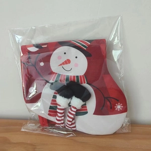Detail of a Christmas snowman stocking bag with festive red and white hanging legs