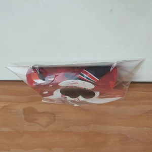Detail of red Christmas stocking with snowman pattern in clear plastic packaging