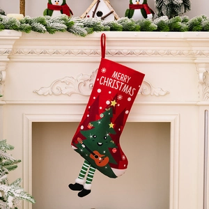 Red Christmas stocking with guitar-playing tree and striped legs on a fireplace