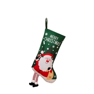 Christmas hanging stocking with Santa print, striped legs, and Merry Christmas text