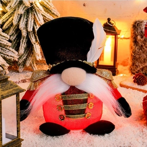 Illuminated Christmas gnome nutcracker soldier with red fabric body and warm LED lights