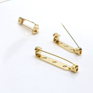 Dettaglio di basi per spille in oro 18k con tre fori di posizionamento per gioielli fai-da-te