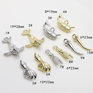 Detail of dolphin and hand gesture charms in gold and silver finish with dimensions