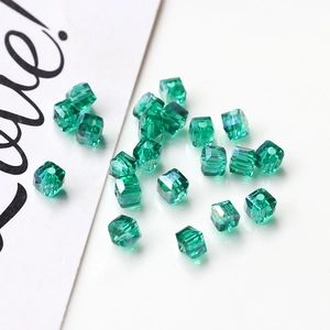 Macro shot of green faceted square crystal beads for DIY handmade jewelry crafts