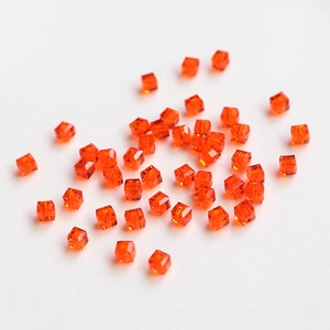 Macro shot of orange faceted square crystal beads for DIY jewelry and necklace crafting