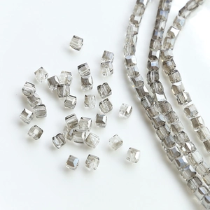 Macro shot of smoky grey square cut crystal beads with center hole for DIY jewelry making