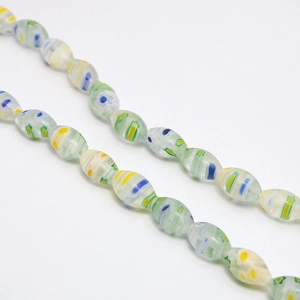 Macro detail of oval Millefiori glass beads with colorful floral and stripe patterns