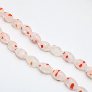 Close-up of oval millefiori glass beads with orange floral patterns for DIY jewelry