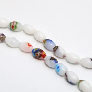Macro detail of oval Millefiori glass beads with colorful floral patterns for DIY jewelry
