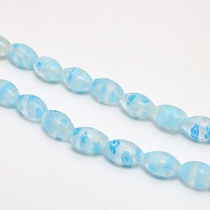 Macro close-up of light blue millefiori glass bead with floral and striped interior pattern