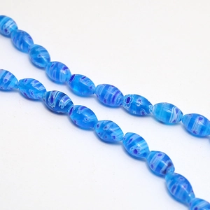 Close-up of blue floral millefiori glass beads with intricate swirl patterns for DIY jewelry