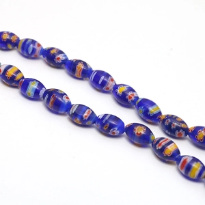 Macro detail of blue millefiori glass beads with colorful floral and stripe patterns