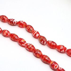 Macro shot of red oval Millefiori glass bead with floral patterns for jewelry making