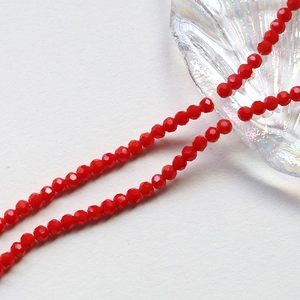 Macro view of 4mm faceted bright red crystal beads for DIY handmade jewelry crafting