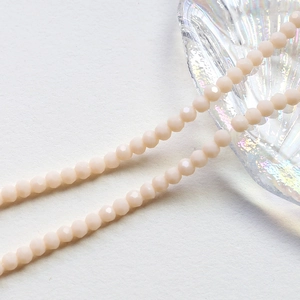 Macro shot of 4mm faceted beige crystal wheel beads for DIY jewelry making and crafts