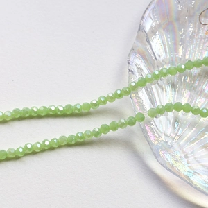 Macro shot of 4mm faceted light green crystal rondelle beads for jewelry making DIY