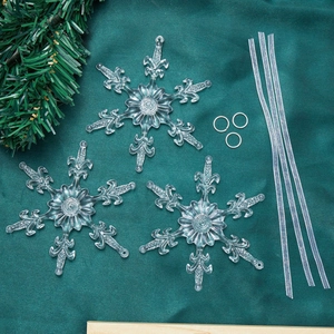 Three clear acrylic snowflake ornaments with silver ribbons for Christmas tree decor