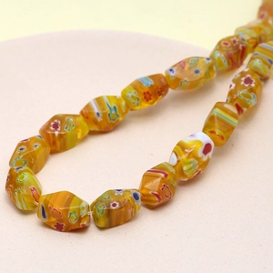 Close-up of yellow Millefiori faceted glass beads for DIY jewelry making