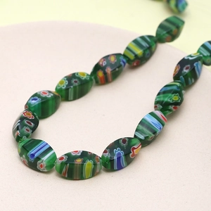 Detailed macro view of millefiori floral glass beads in olive shape for jewelry