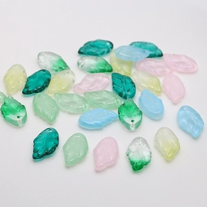 Macro shot of 11x19mm translucent leaf-shaped glass beads with pre-drilled holes
