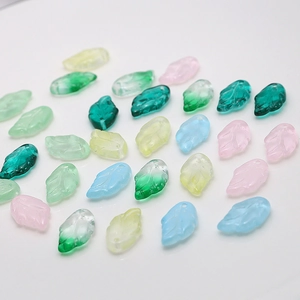 Transparent leaf-shaped glass charms with detailed veins in various gradient colors