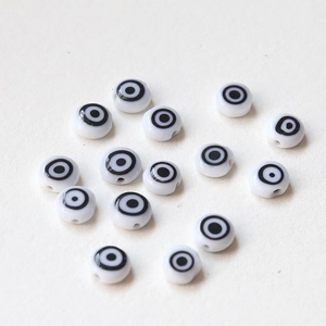 Macro shot of evil eye beads with smooth finish and central drill holes for DIY jewelry