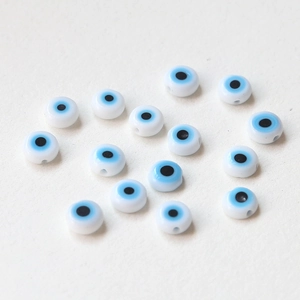 Macro shot of flat glass evil eye beads for DIY handmade jewelry crafting and beading