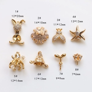 Detailed view of 8 gold-plated jewelry pendants with zircon inlays for DIY jewelry making