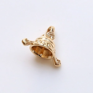 Detail of gold-plated bell-shaped pearl cap with intricate vintage floral engraving