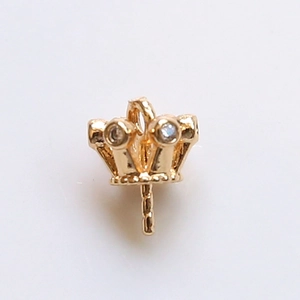 Macro shot of gold-plated crown pendant cap with sparkling zircon for DIY pearl jewelry