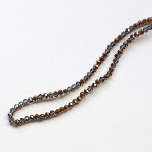 Macro detail of faceted crystal rondelle beads in bronze and smoky gray for DIY jewelry