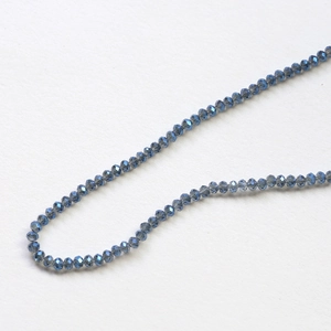 Macro detail of faceted dark blue rondelle glass beads for DIY jewelry making