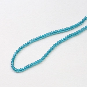 Macro detail of faceted lake blue crystal wheel beads for DIY jewelry making and crafts