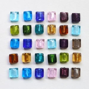 Macro view of square glass beads with gold foil foil interior for DIY jewelry making