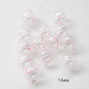 Macro detail of 16mm hollow glass beads with pink and purple striped patterns for DIY