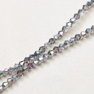 Macro view of 4mm faceted bicone crystal glass beads with dark grey AB rainbow coating