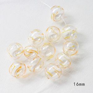 Detail of 16mm hollow glass beads with orange swirls for DIY jewelry making