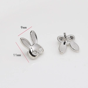 Detailed view of silver rabbit head studs showing front and back with size measurements