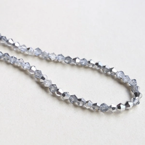 Macro view of 4mm faceted bicone crystal glass beads in metallic grey for DIY jewelry