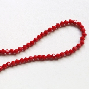 Macro shot of red faceted crystal bicone beads for DIY jewelry and handmade bracelets