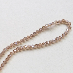 Macro view of 4mm faceted champagne bicone crystal beads for DIY jewelry making